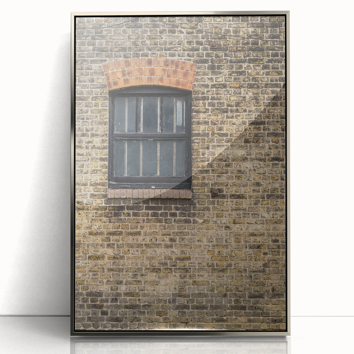 Mid-century modernist art poster featuring geometric shapes in muted earth tones, framed in silver acrylic.