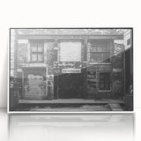 Framed acrylic print of an art deco poster featuring geometric patterns in black and gold.