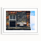 Abstract art print featuring swirling blue and gray patterns on a white framed canvas.