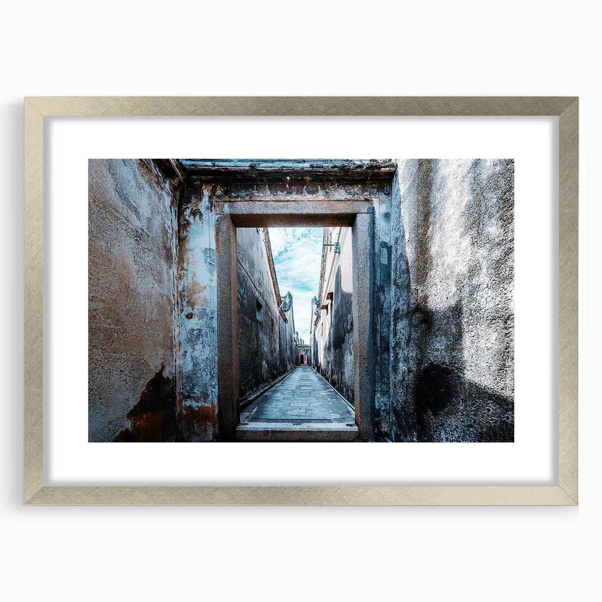 Textured abstract art print in silver frame, featuring swirling gray and white patterns, ideal for modern bedroom decor.