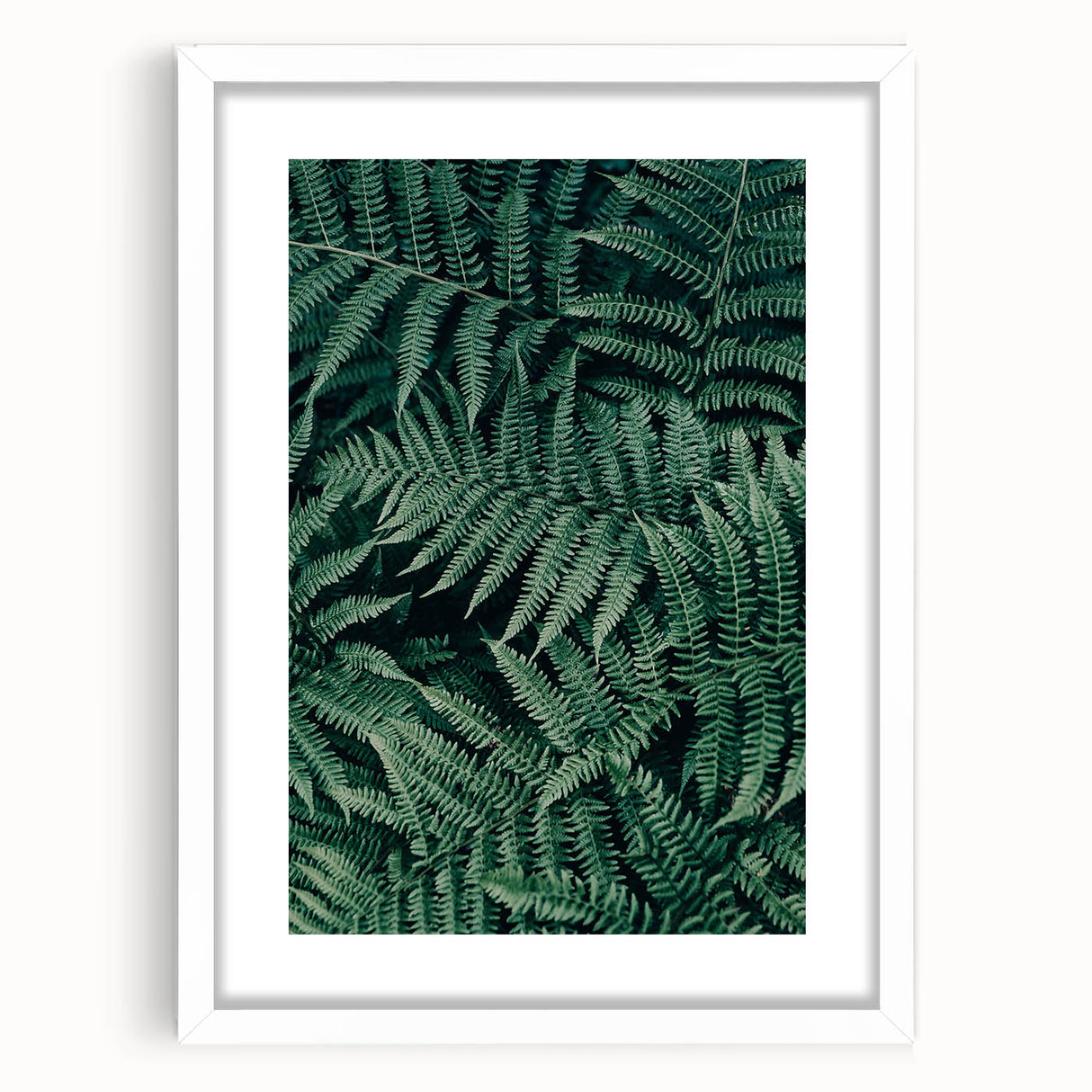 White picture frame with a mat, showcasing a blank space ideal for artwork or photographs, set against a neutral background. Perfect for home decor or gallery displays.