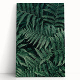 Stretched canvas artwork featuring a vibrant abstract design with bold colors, leaning against a textured wall, ideal for modern home decor.