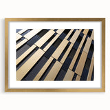 Textured abstract art print in muted gold and cream tones, framed in gold, ideal for bedroom wall decor.