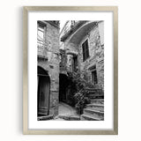 Textured art print featuring abstract swirls in muted gray and silver, displayed in a silver frame.