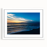 Abstract art print featuring swirls of blue and grey hues on a framed white canvas.