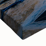 Large art of a black and white landscape painting on stretched canvas, featuring a serene tree-lined river.