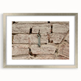 Textured abstract art print in muted gray and blue tones on framed canvas, suitable for modern bedroom decor.