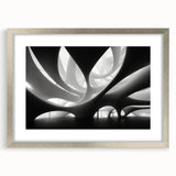 Abstract art print featuring swirling blue and silver patterns on a framed canvas, suitable for dining room decor.