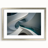 Abstract art print featuring swirling blue and gray tones on a framed canvas, suitable for bedroom or dining room decor.