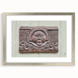 Textured abstract art print in silver frame, featuring swirling gray and white patterns, ideal for modern bedroom ambiance.