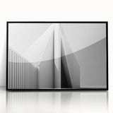 Large abstract wall art featuring swirling blue and gray tones on a framed acrylic print, suitable for modern art wall decor.