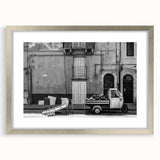 Textured abstract art print in silver frame, featuring swirling gray and white patterns, ideal for modern bedroom ambiance.