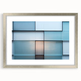 Abstract art print featuring swirling blue and silver patterns on a framed canvas, suitable for dining room or bedroom decor.