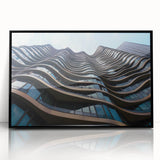 Large abstract wall art featuring swirling blue and gray tones on acrylic, framed, ideal for modern living room decor.