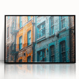 Large abstract wall art in vibrant blue and orange tones, framed in black acrylic, suitable for modern living room decor.