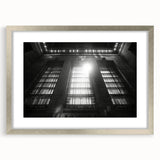 Abstract art print featuring swirling blue and silver tones on a framed canvas, suitable for dining room or bedroom decor.