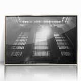 Art deco poster featuring geometric patterns in black and silver tones, framed in acrylic.