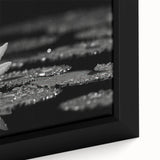Vibrant close-up of a floral canvas print showcasing intricate details of colorful flowers and lush green leaves, perfect for home decor enhancement.