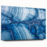 Large abstract wall art featuring swirling blue and green tones on canvas, ideal for bedroom or dining room decor.