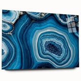 Large abstract wall art featuring swirling blue and gray tones on canvas, ideal for bedroom or dining room decor.