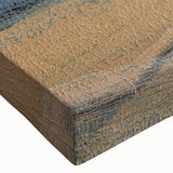 Close-up of a stretched canvas wall art piece showcasing an abstract landscape design with vibrant hues of blue, green, and orange textures, perfect for modern decor.