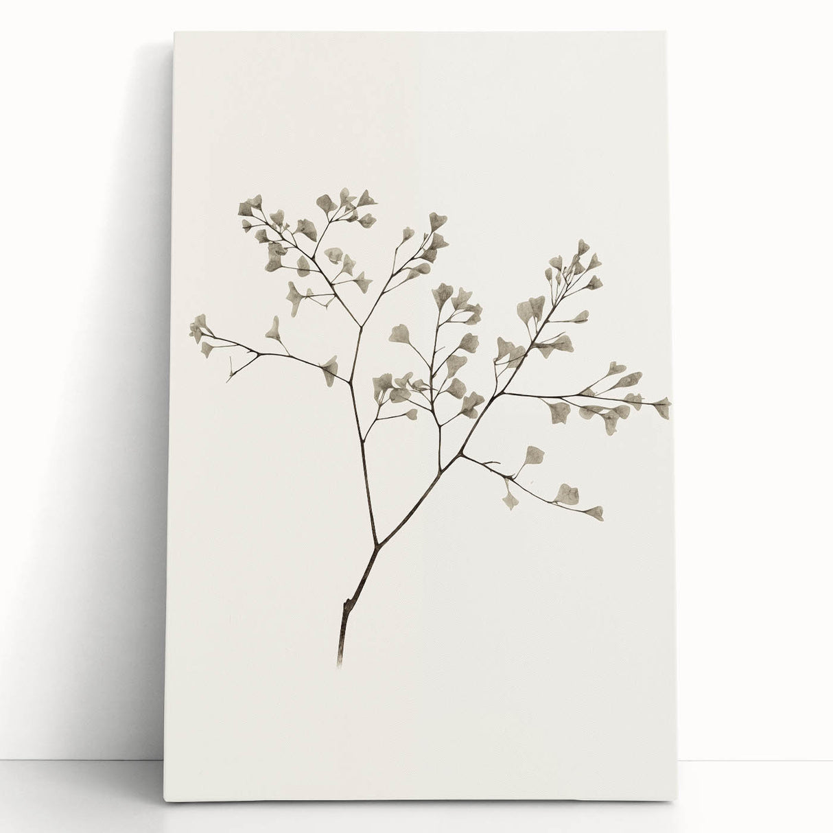 Abstract minimalist design wall art collection on stretched canvas, featuring soft earth tones and geometric shapes, leaning against a neutral wall, enhancing modern decor.