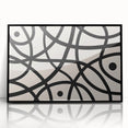 Framed acrylic wall art featuring an abstract minimalist design in black and white, showcasing geometric shapes and smooth lines, perfect for modern decor.