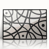 Framed acrylic wall art featuring an abstract minimalist design in black and white, showcasing geometric shapes and smooth lines, perfect for modern decor.
