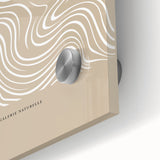 Close-up of abstract minimalist wall art featuring soft earth tones and geometric shapes, showcasing a modern acrylic glass finish for contemporary decor.