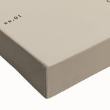 Close-up of an abstract minimalist wall art piece on stretched canvas, showcasing soft earth tones and geometric shapes for modern decor.