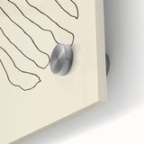 Close-up of an abstract minimalist wall art piece featuring soft pastel colors and geometric shapes, displayed under acrylic glass for a sleek finish. Perfect for modern home decor.