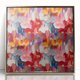 Framed abstract wall art design with vibrant splatters in gold and blue hues, adding a modern touch to any decor setting.