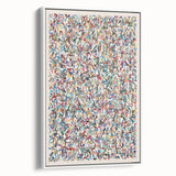 Framed wall art featuring an abstract splatter design in vibrant colors, set against a white background, showcasing a modern artistic style.