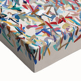 Close-up of a vibrant abstract splatter design on stretched canvas, showcasing bold colors and dynamic patterns, perfect for modern wall decor.