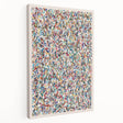Abstract wall art design featuring vibrant splatter patterns in blue, yellow, and orange on a stretched canvas, showcasing a modern aesthetic ideal for contemporary decor.