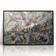 Framed abstract wall art featuring colorful splatter designs on an acrylic surface, showcasing a modern aesthetic with a sleek black frame.
