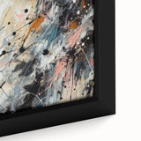 Close-up of framed abstract splatter wall art featuring vibrant colors of blue, yellow, and red, perfect for modern home decor.
