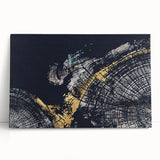 Abstract wall art featuring vibrant strokes and lines in shades of blue, yellow, and orange on a stretched canvas, leaning against a neutral wall, perfect for modern decor.