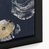 Close-up of a framed canvas wall art piece showcasing an abstract design with vibrant strokes and lines in shades of blue, orange, and cream, perfect for modern decor.
