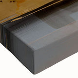 Close-up of an abstract wall art canvas featuring vibrant strokes and lines in shades of blue, yellow, and pink, perfect for modern decor.