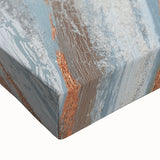 Close-up view of an abstract wall art design featuring vibrant strokes and lines in shades of blue, gold, and white, showcasing a modern artistic expression on stretched canvas. This piece enhances contemporary decor and adds a touch of elegance to any space.