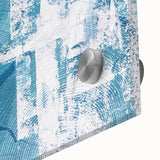 Close-up of an abstract wall art piece featuring vibrant strokes and lines in shades of blue, orange, and yellow, designed for modern decor and artistic expression.