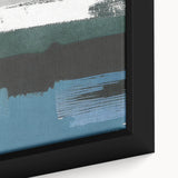 Close-up of a framed abstract wall art piece showcasing vibrant strokes and lines in shades of blue, orange, and yellow, ideal for modern home decor.