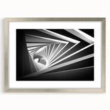 Abstract art print featuring geometric shapes in muted gray and silver, framed in a sleek silver frame.