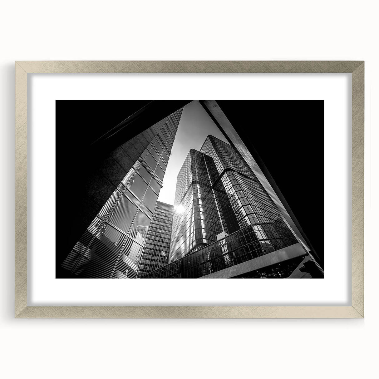 Abstract art print featuring geometric shapes in muted gray and blue tones on a framed silver mat.