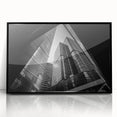 Large abstract wall art featuring geometric shapes in muted gray and blue tones on a black framed acrylic print.