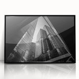 Large abstract wall art featuring geometric shapes in muted gray and blue tones on a black framed acrylic print.