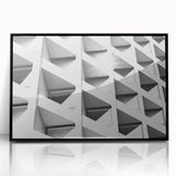 Framed acrylic print of large abstract wall art featuring geometric shapes in muted earth tones.