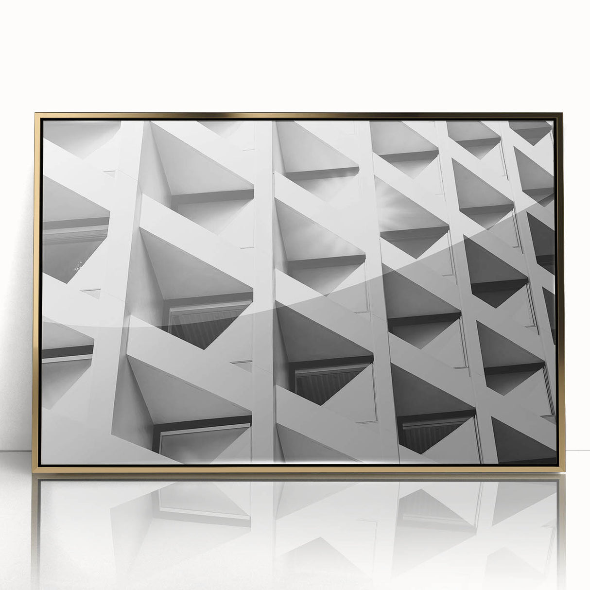 Mid-century modernist art depicting abstract architecture in gold and black tones on a framed acrylic print.
