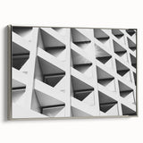 Framed canvas depicting a vintage poster art of abstract architecture in black with colorful accents.